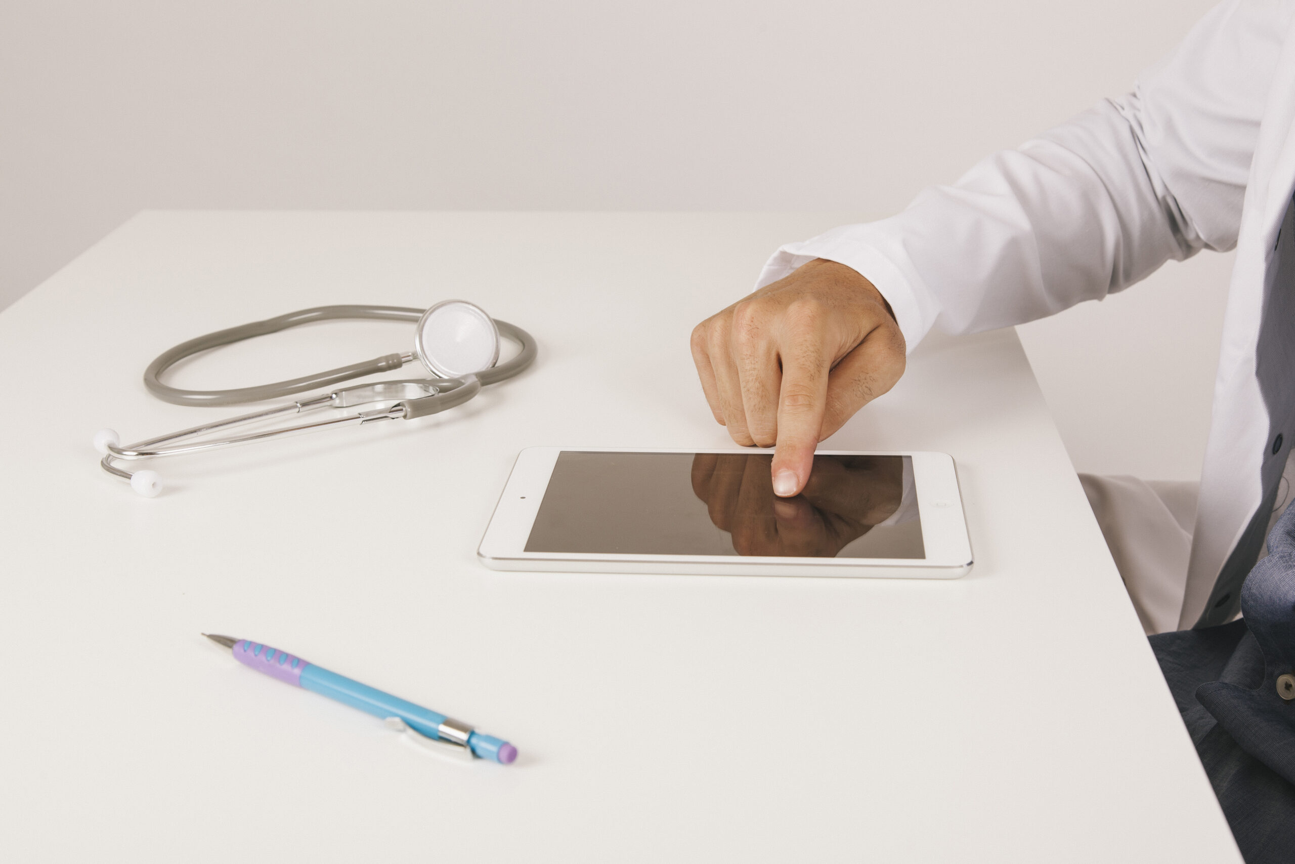 doctor-s-hand-touching-tablet-s-screen